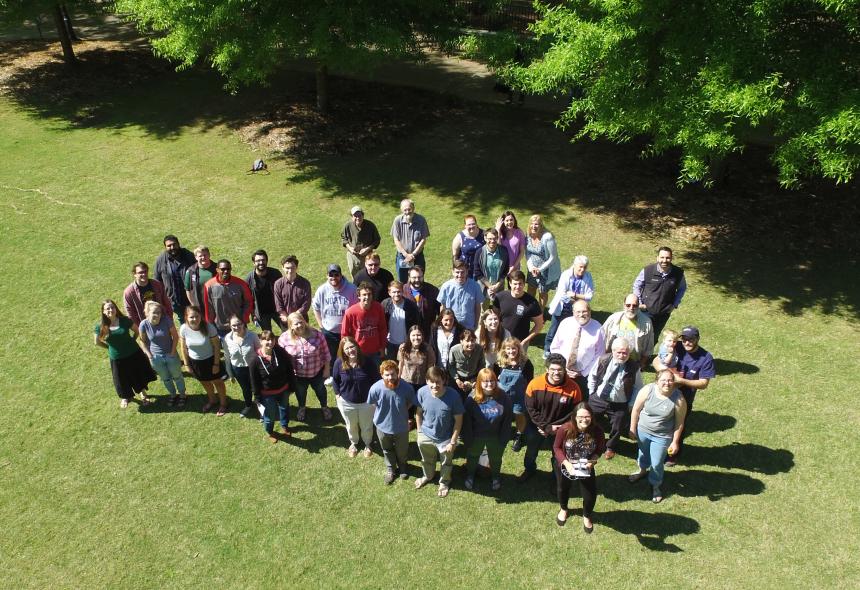 A bird's eye view of Geology faculty, staff and students stand on the quad. Taken by Melanie Callihan with an unmanned aerial system (UAS).
